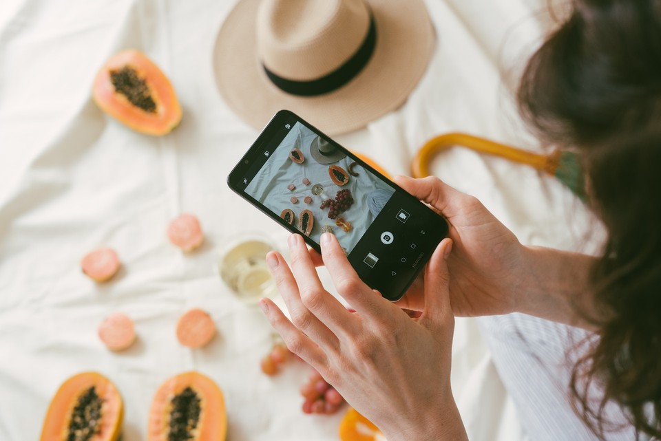 Person taking a photo of an ecommerce product with a smartphone